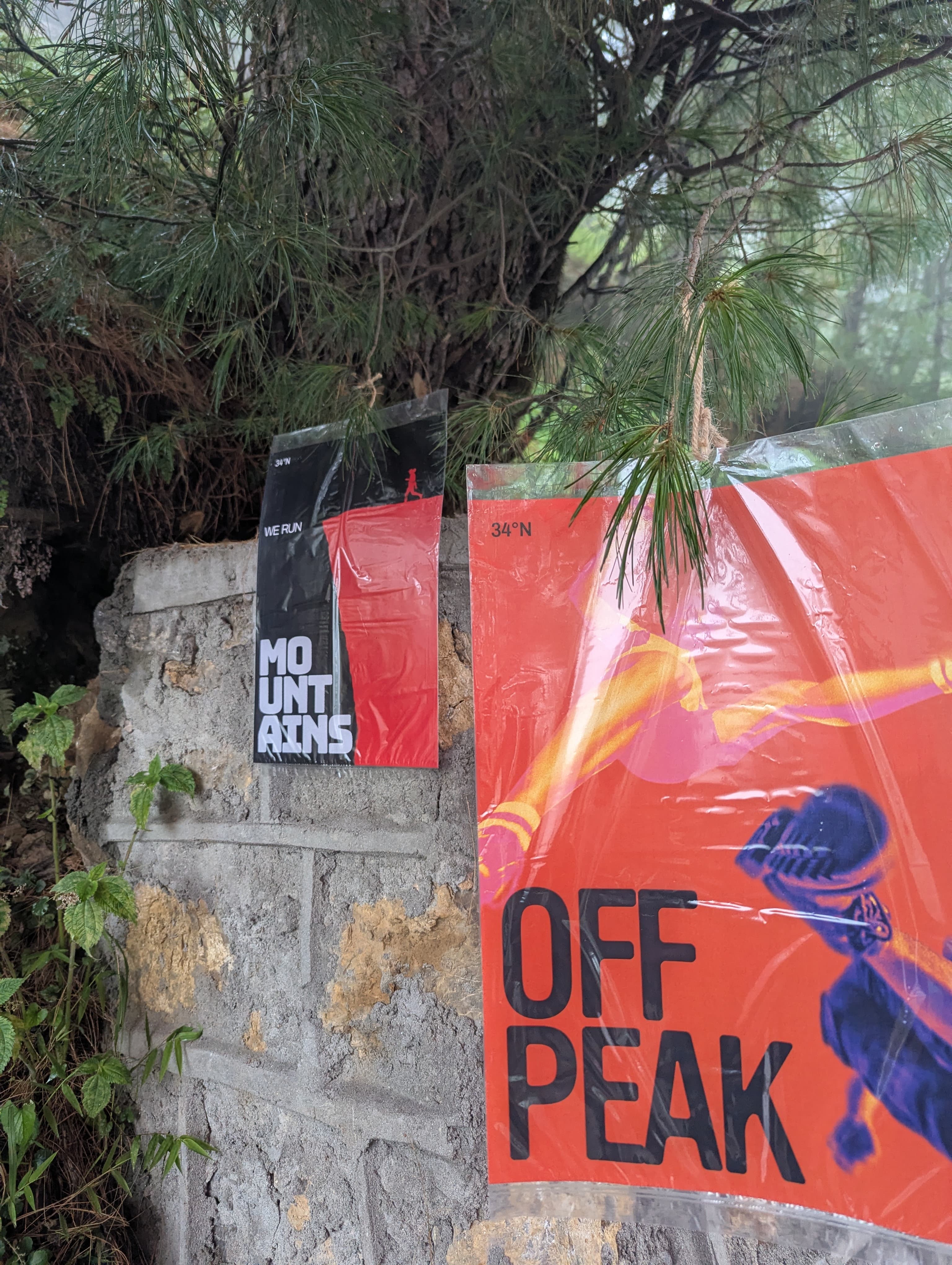 Off Peak posters among mountain greenery
