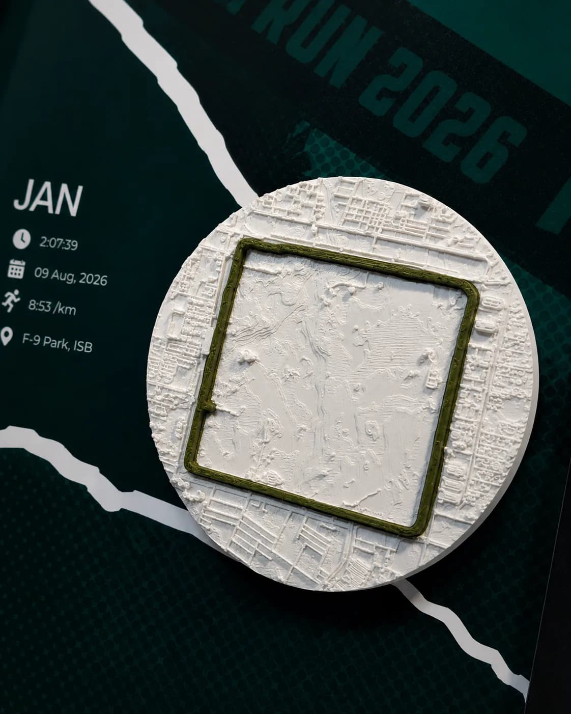 Close view of the white city relief with the green route loop raised on top